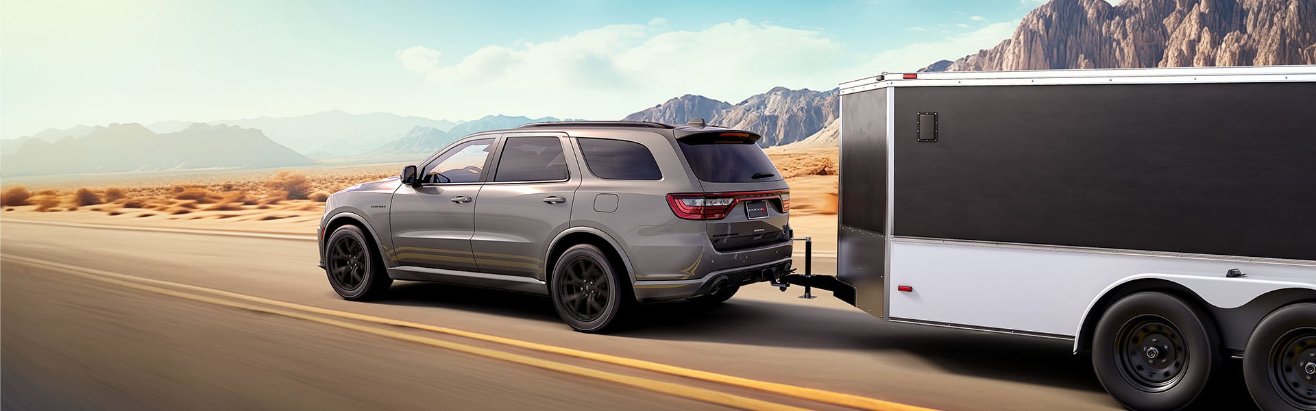 A powerful Dodge Durango parked against the backdrop of the rugged Wyoming high desert mountains near Rock Springs.