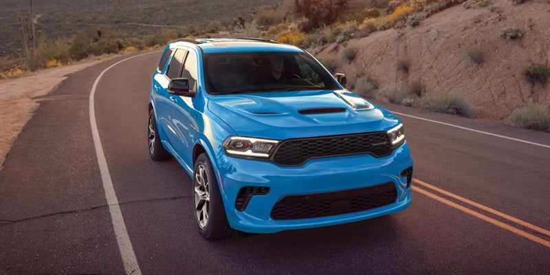 A technical graphic showing how the Dodge All-Wheel Drive system distributes power to all four wheels for maximum winter traction.