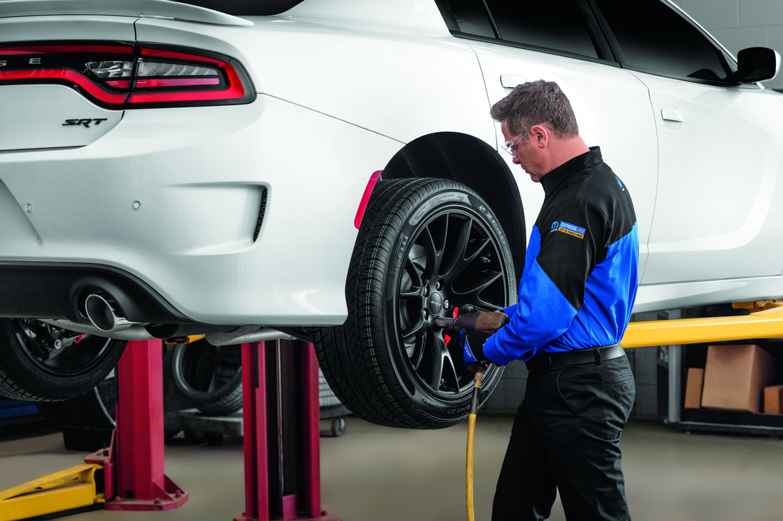 Expert Factory-Trained Mopar Technician Inspecting Braking System
