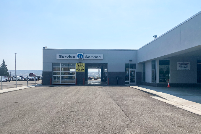 Inside the state-of-the-art Mopar service center at Fremont Motor Rock Springs, showing a Dodge vehicle on a lift for maintenance.